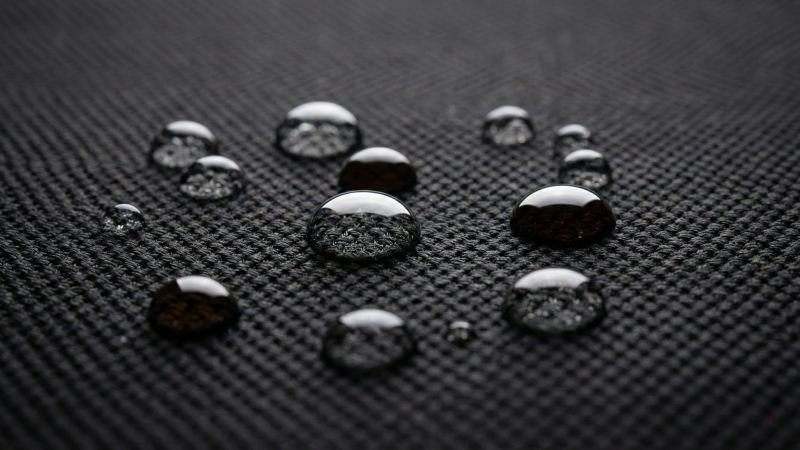Water droplets beading on hydrophobic car mat surface